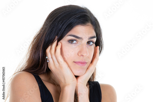 Portrait of young cheerful caucasian woman two hands on face cheeks standing white wall in concept of being confident beauty girl
