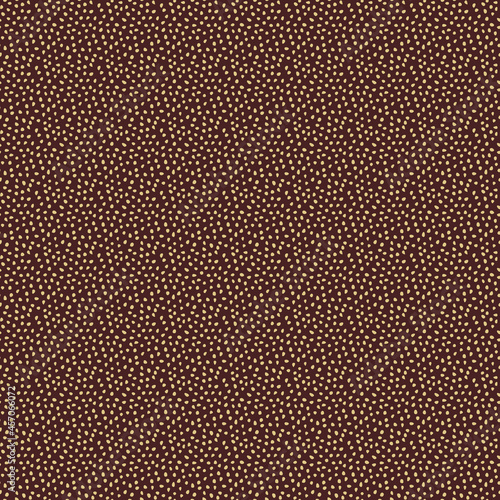 Seamless background with random golden elements. Abstract ornament. Dotted abstract brown and golden pattern