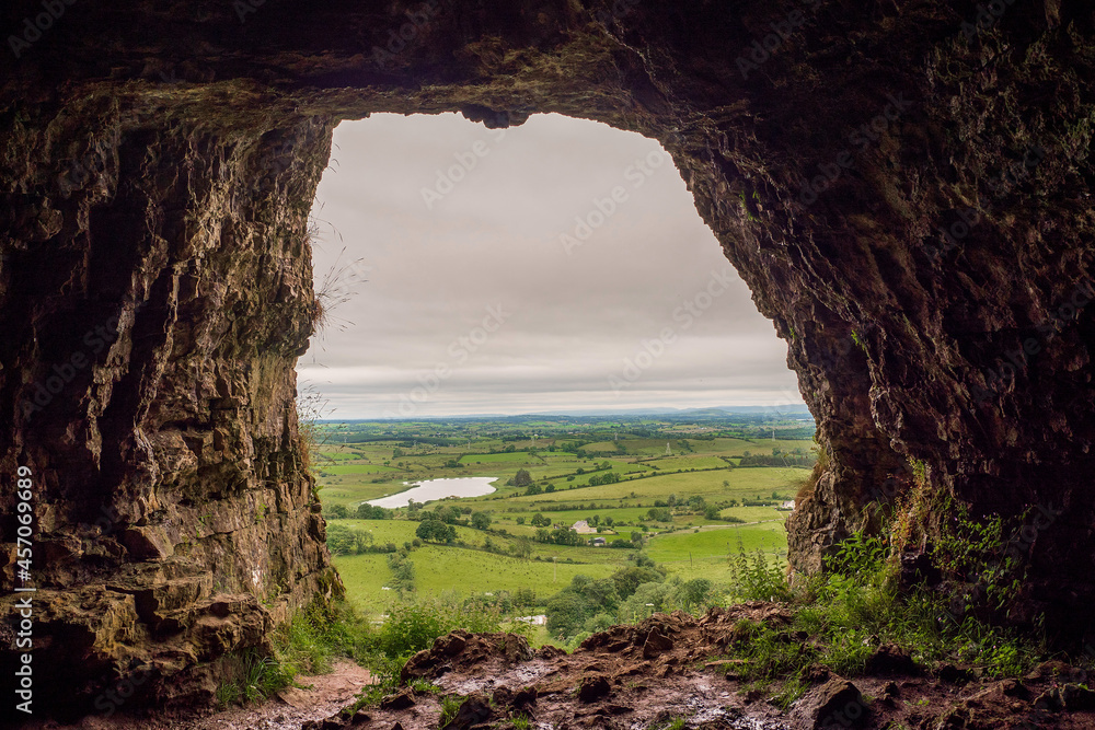 View from a cave on a beautiful scenery. Cloudy sky. Natural frame concept