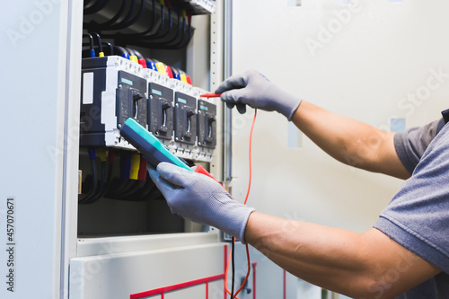 Electrical engineers check electrical control equipment.