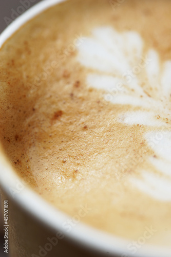 Cappuccino in a paper cup, foam close up