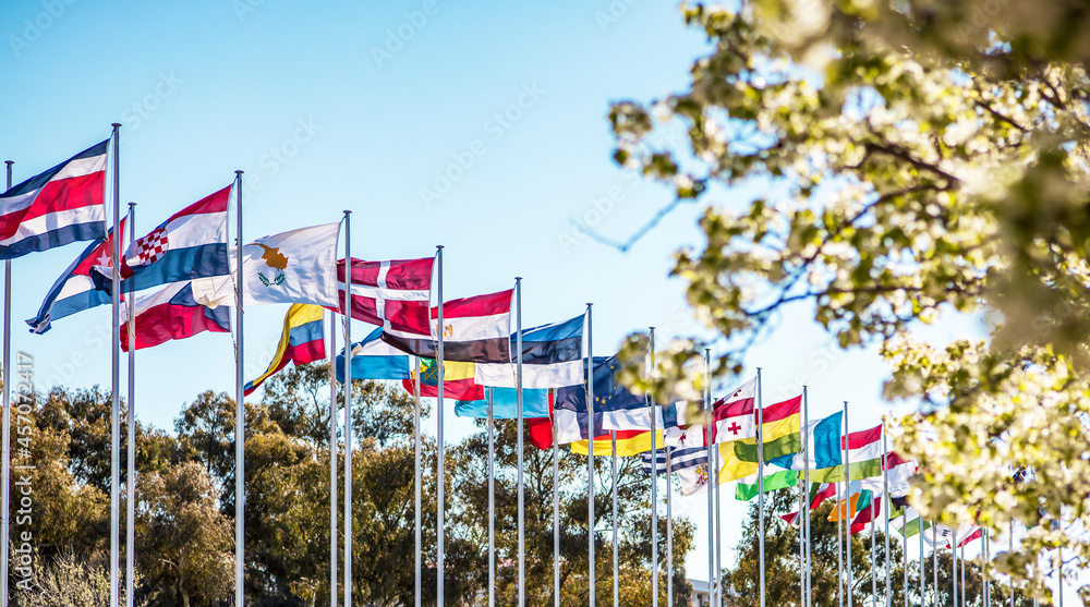 A row of different countries flags on a sunny spring day in Canberra A row of different countries flags on a sunny spring day in Canberra