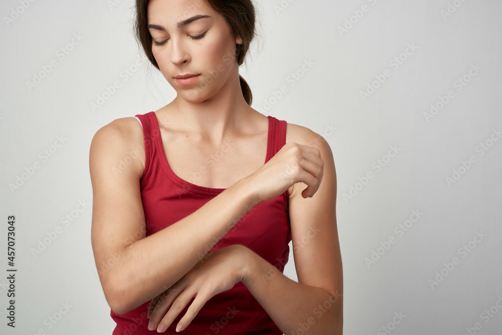 Fototapeta premium woman with joint pain red t shirt health problem medicine rheumatism