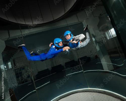 Fotografie, Obraz A man and a woman enjoy flying together in a wind tunnel