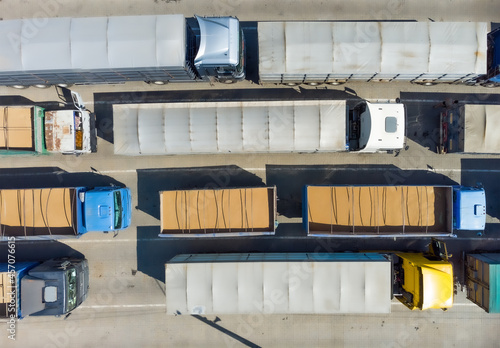 Trucks in the parking lot, top view on a truck. Logistics transport in the parking lot waiting for unloading.