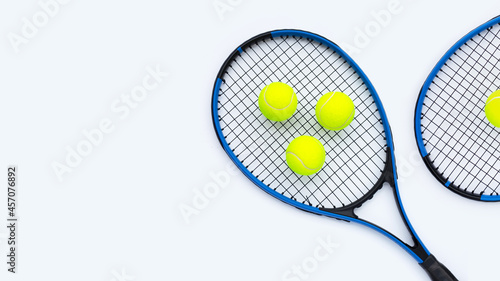 Tennis rackets with balls on white. © Bowonpat