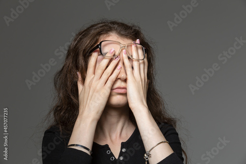 Tired young woman rubbing eyes
 photo