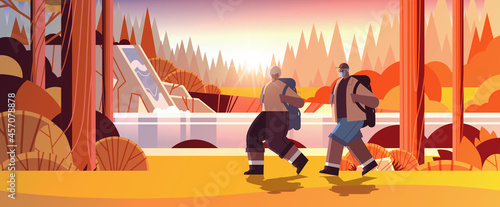 senior african american man woman hikers traveling together with backpacks active old age physical activities