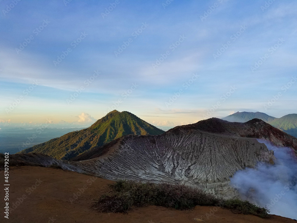 Atop Mount Ijen, standing on the edge of a volcano in Indonesia Atop Mount Ijen, standing on the edge of a volcano in Indonesia