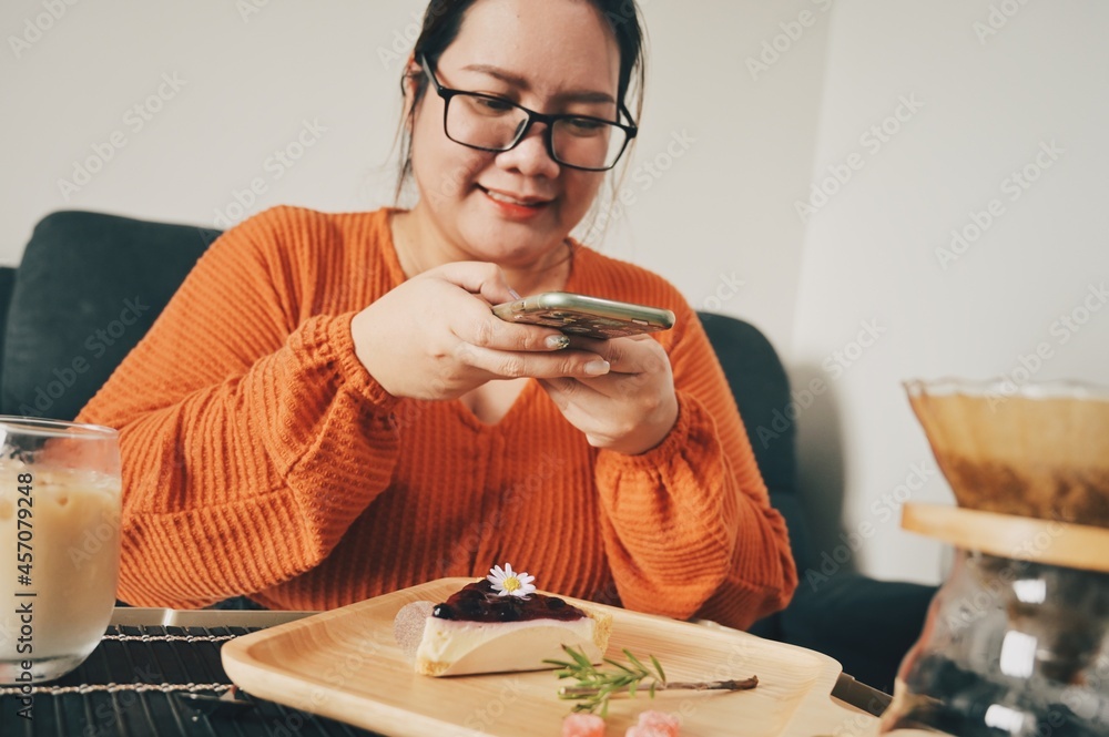 Asian woman enjoyed the bakery and coffee at home. Asian woman enjoyed the bakery and coffee at home.