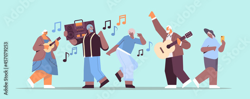 mix race senior people with bass clipping blaster recorder dancing and singing grandparents having fun active old age