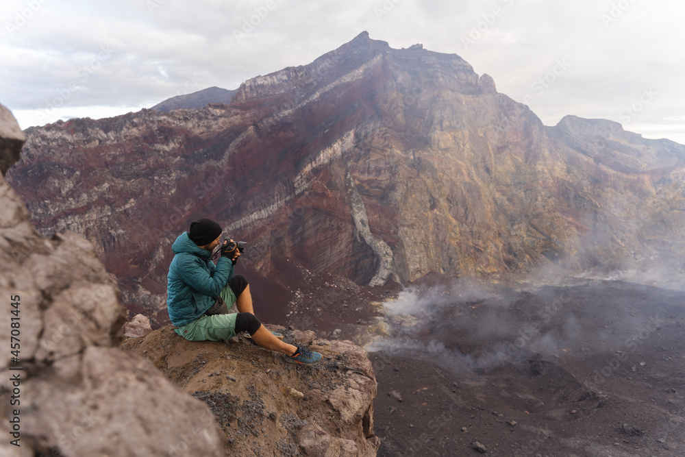The photographer takes pictures in the mountains, volcano Agung, Bali.