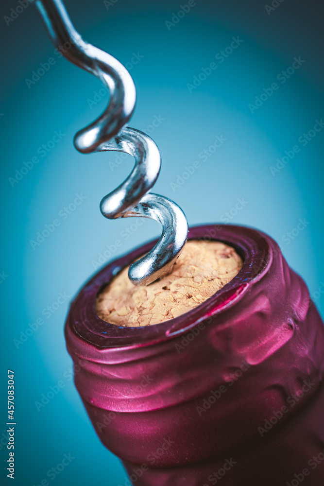 Wine bottle and wine opener on blue Wine bottle and wine opener on blue