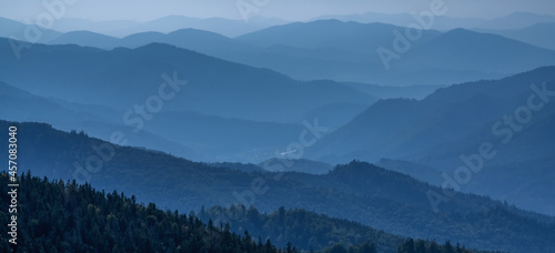Fototapeta Naklejka Na Ścianę i Meble -  High peaks of beautiful dark blue mountain range landscape with fog and forest. Ukraine, Carpathians.
