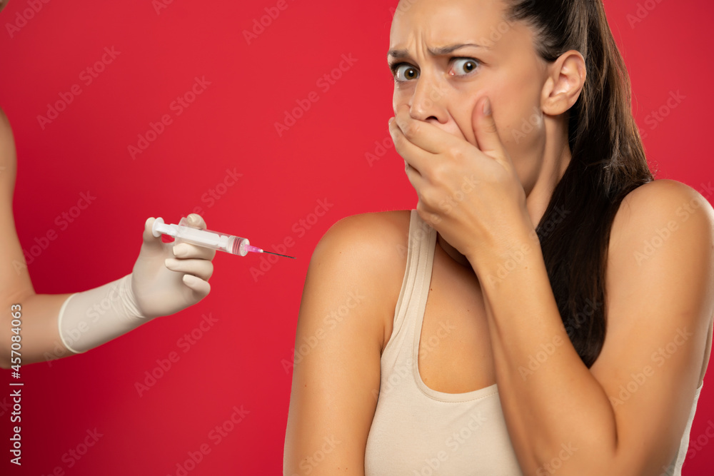 Fototapeta premium a young woman is afraid to be vaccinated