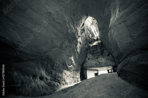 An old abandoned sandstone cellar, a hidden cave in the forest photo