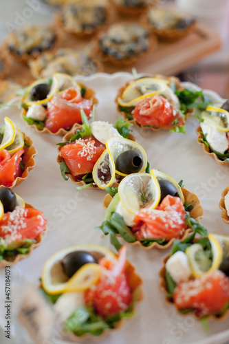 tartlets appetizers with salmon on big white platter