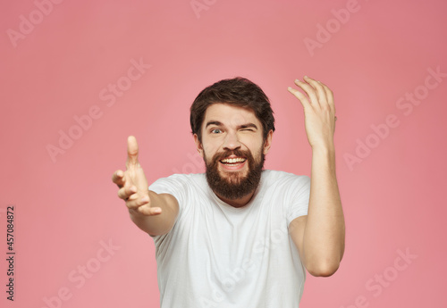 Man in a white t-shirt expressive look discontent Studio