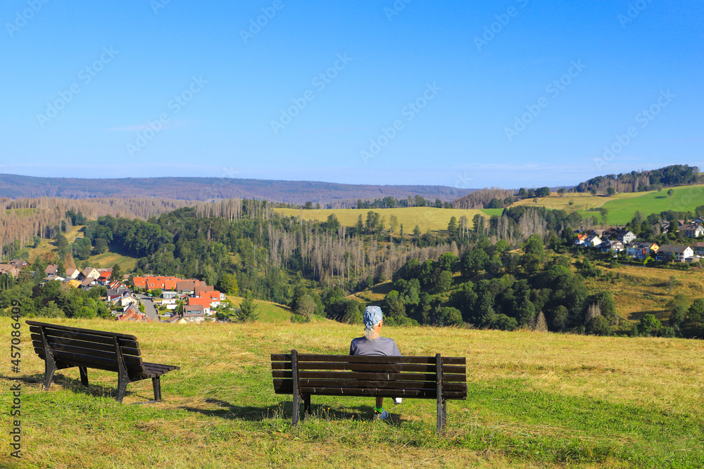 A man is watching to Sankt Andreasberg, Harz mountains - Germany A man is watching to Sankt Andreasberg, Harz mountains - Germany