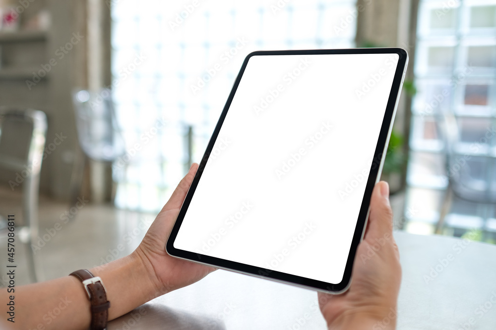 Fototapeta premium Mockup image of a woman holding digital tablet with blank white desktop screen