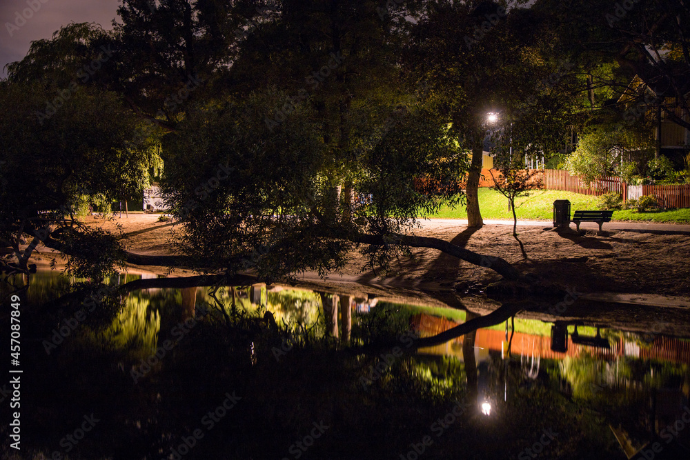 Obraz premium Stockholm, Sweden An illuninated path by the water at night.