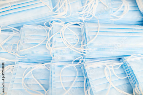 Pile of medical masks stacked and ready for shipping. Close up of blue respiratory face masks.