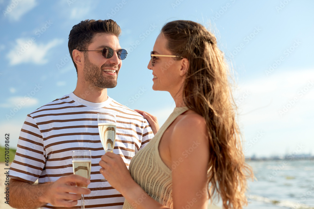 leisure, relationships and people concept - happy couple in sunglasses drinking champagne on summer beach leisure, relationships and people concept - happy couple in sunglasses drinking champagne on summer beach