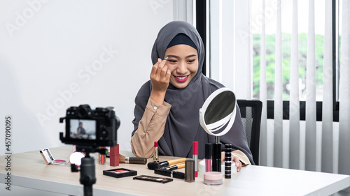 Asian muslim woman beauty blogger tutorial eyebrow techniques and making videos to review cosmetic