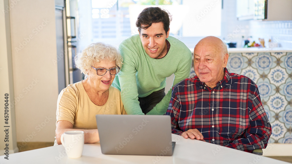 Son explains video streaming online to senior parents Son explains video streaming online to senior parents