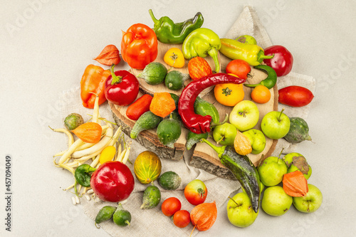 Trendy ugly organic vegetables and fruits on stone concrete background