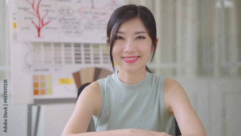 Close up portrait young Asian woman smiling in office Close up portrait young Asian woman smiling in office