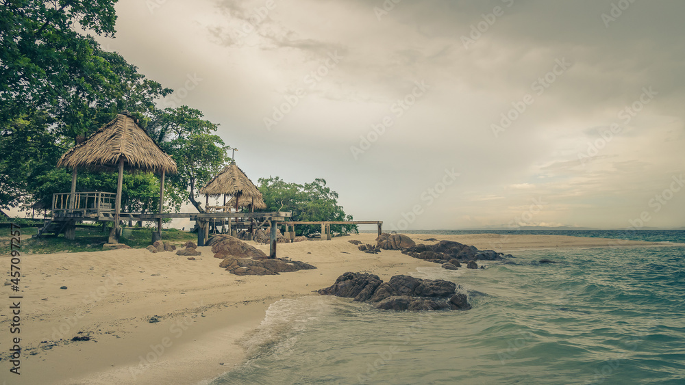 Nature in twilight period which including of sunrise over the sea and the nice beach. Summer beach with blue water and purple sky at the sunset.	
