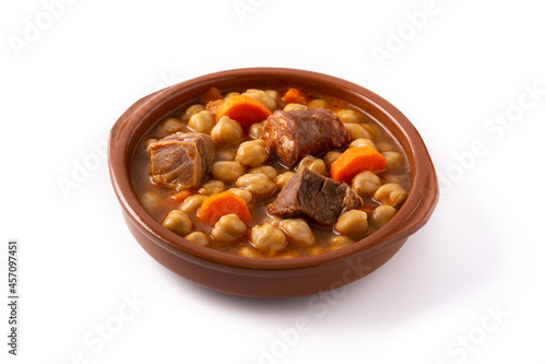 Traditional Spanish cocido madrileño in bowl isolated on white background