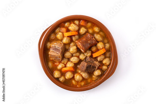 Traditional Spanish cocido madrileño in bowl isolated on white background