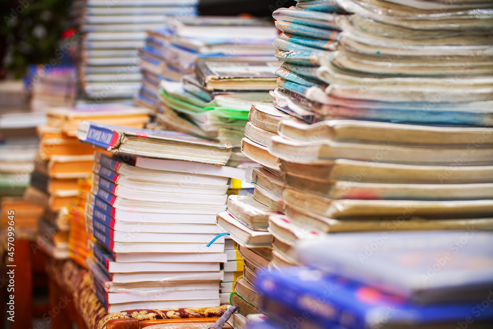 Fototapeta premium Stacks of old books in the library. Selective Focus