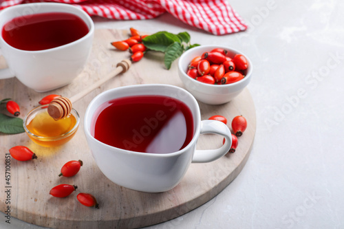 Fresh rose hip tea and berries on light table