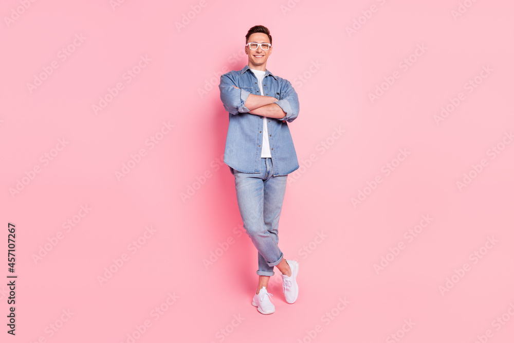 Full size photo of young handsome cheerful businessman with folded hands wear glasses isolated on pink color background Full size photo of young handsome cheerful businessman with folded hands wear glasses isolated on pink color background