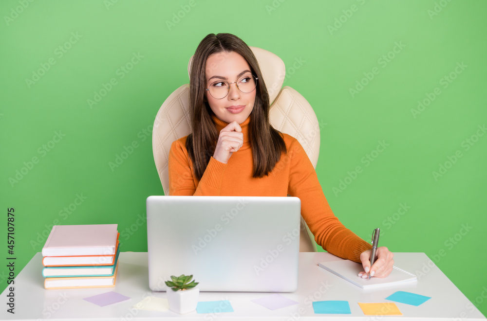 Portrait of attractive cheery trendy skilled minded girl creating strategy writing to-do list isolated over bright green color background Portrait of attractive cheery trendy skilled minded girl creating strategy writing to-do list isolated over bright green color background