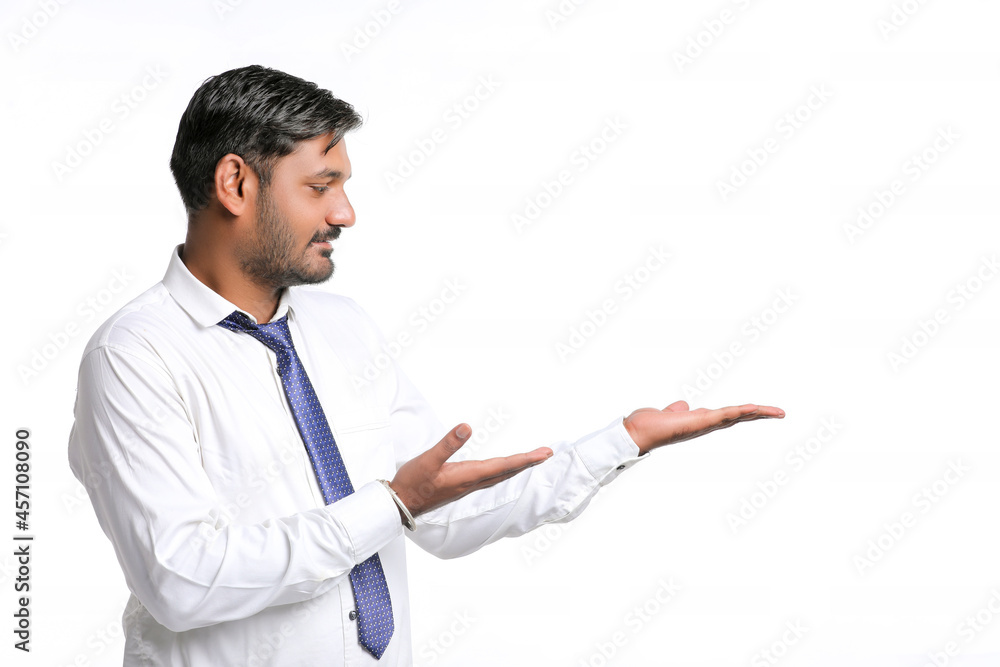 Young indian man showing expression on white background Young indian man showing expression on white background