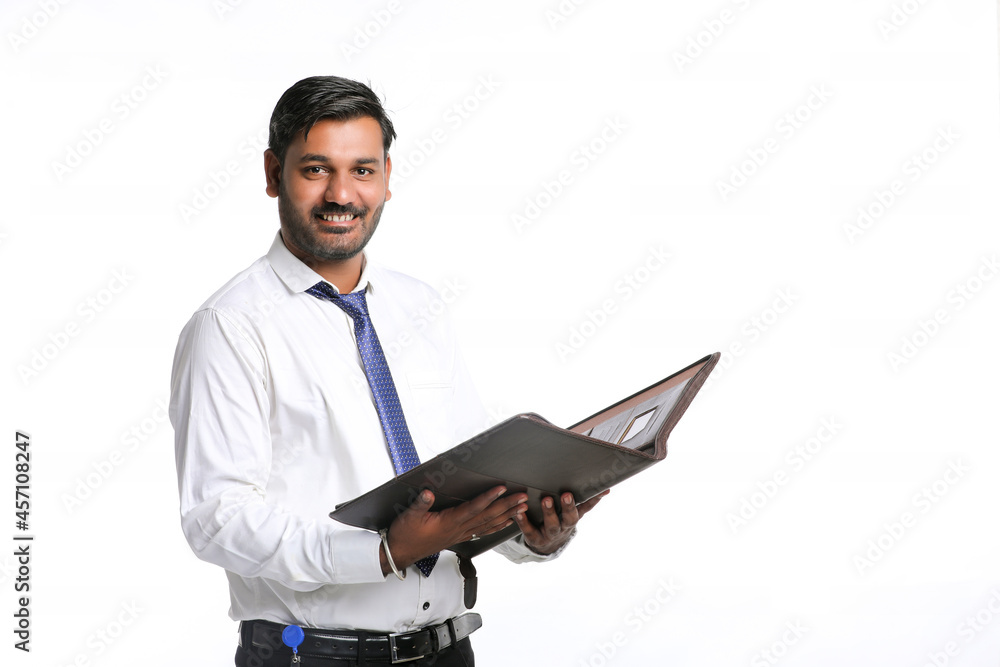 Young indian student or officer holding file in hand Young indian student or officer holding file in hand