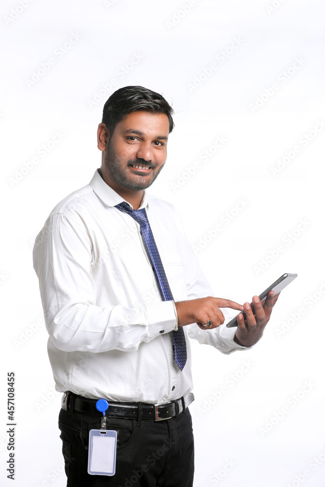 Young indian man using smartphone on white background. Young indian man using smartphone on white background.