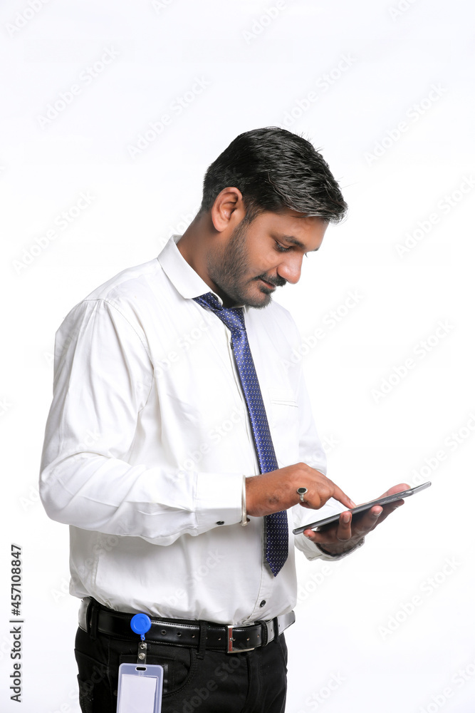 Young indian man using smartphone on white background. Young indian man using smartphone on white background.