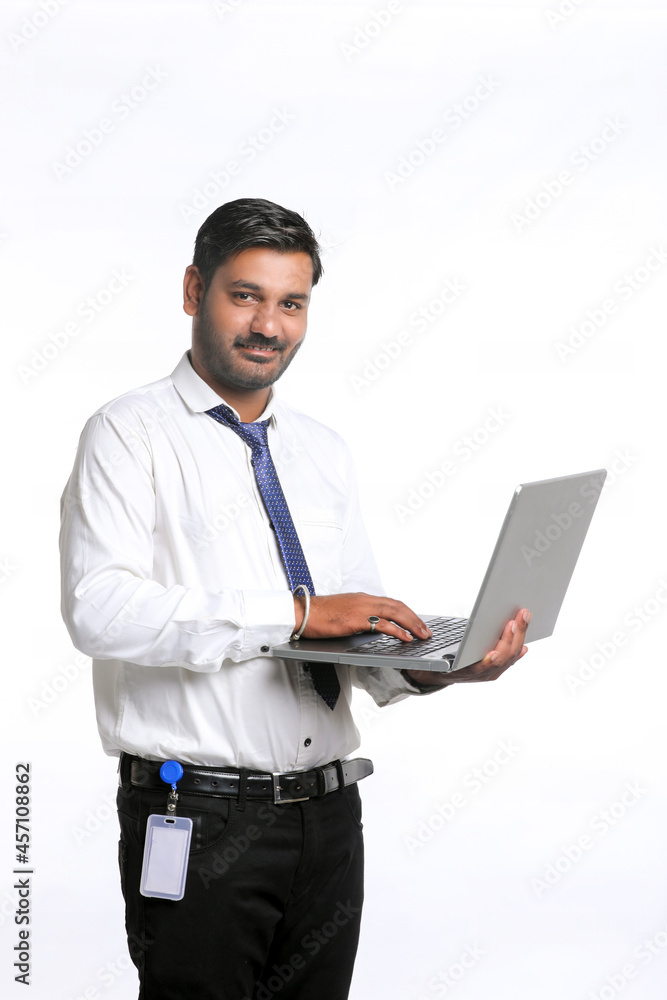 Young indian man using laptop on white background. Young indian man using laptop on white background.