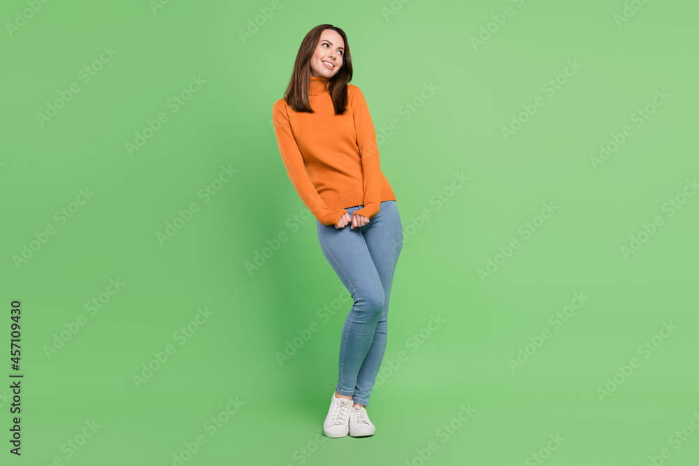 Full length body size view of attractive cheerful girlish girl posing thinking copy space isolated over green color background Full length body size view of attractive cheerful girlish girl posing thinking copy space isolated over green color background