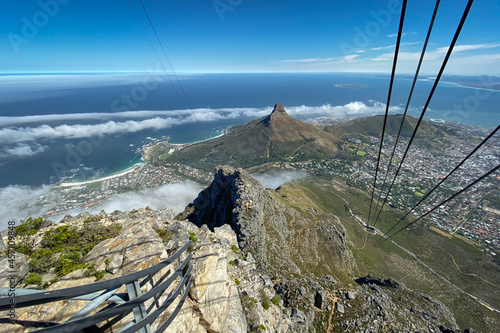 Panoramic view of Cape Town, Lions Head and Camps Bay with cable of cable car in foreground.