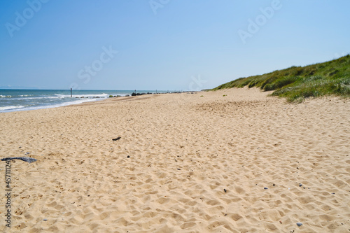 Fototapeta Naklejka Na Ścianę i Meble -  A warm brght, blue sky summer day on Horsey Beach, Norfolk