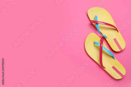 Stylish flip flops on pink background, flat lay. Space for text