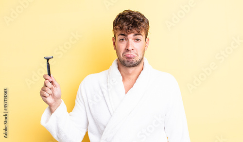 young handsome man feeling sad and whiney with an unhappy look and crying. shaving concept photo