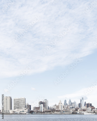 city skyline with large blue sky - space for copy and typography - soft cloud texture - buildings - river - waterway - winter season - wanderlust - city travel - world travel