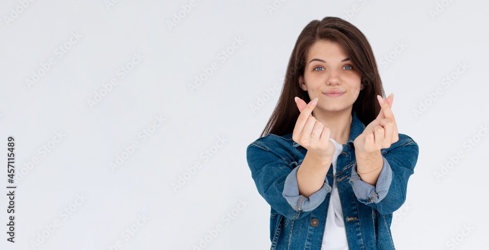 Speading love and happiness. European girl showing heart sign Speading love and happiness. European girl showing heart sign